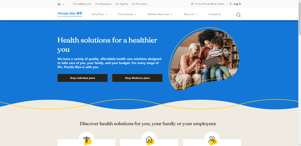 The hero section on the Florida Blue home page in 2023. It shows a banner with the title “Health solutions for a healthier you” in white font. The text sits against a bright blue color. The border of the section has a curved edge as does the image of the grandmother, mother, and child featured in the section.