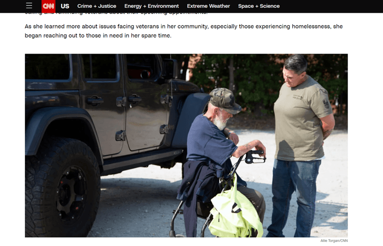 A person in a wheelchair next to a person in a jeep. CNN.