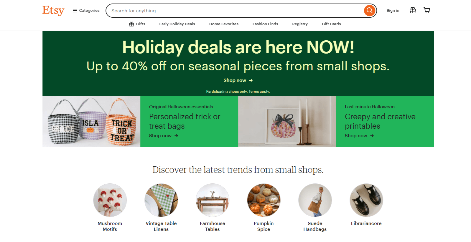 The hero section on the Etsy home page shows that “Holiday deals are here NOW!” for up to 40% off. There are also sections for original Halloween essentials, Halloween creepy and creative printables, along with the latest trends like mushroom motifs, vintage table linens, and pumpkin spice.